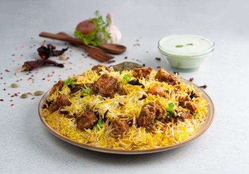 indian-spicy-mutton-biryani-with-raita-gulab-jamun-served-dish-side-view-grey-background_689047-1194-transformed